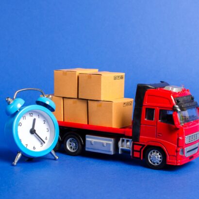 A red truck with cardboard boxes and a blue alarm clock