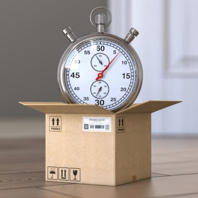 Express delivery concept. Stopwatch and cardboard box on the floor in front of open door.